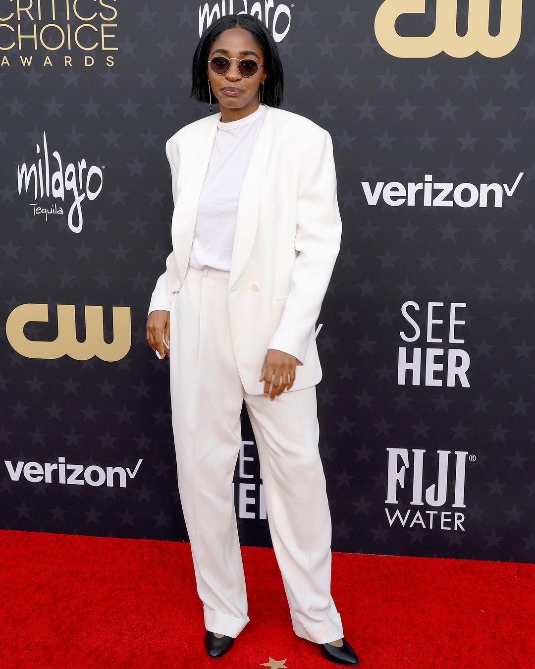 ayo edebiri wearing white suit on red carpet