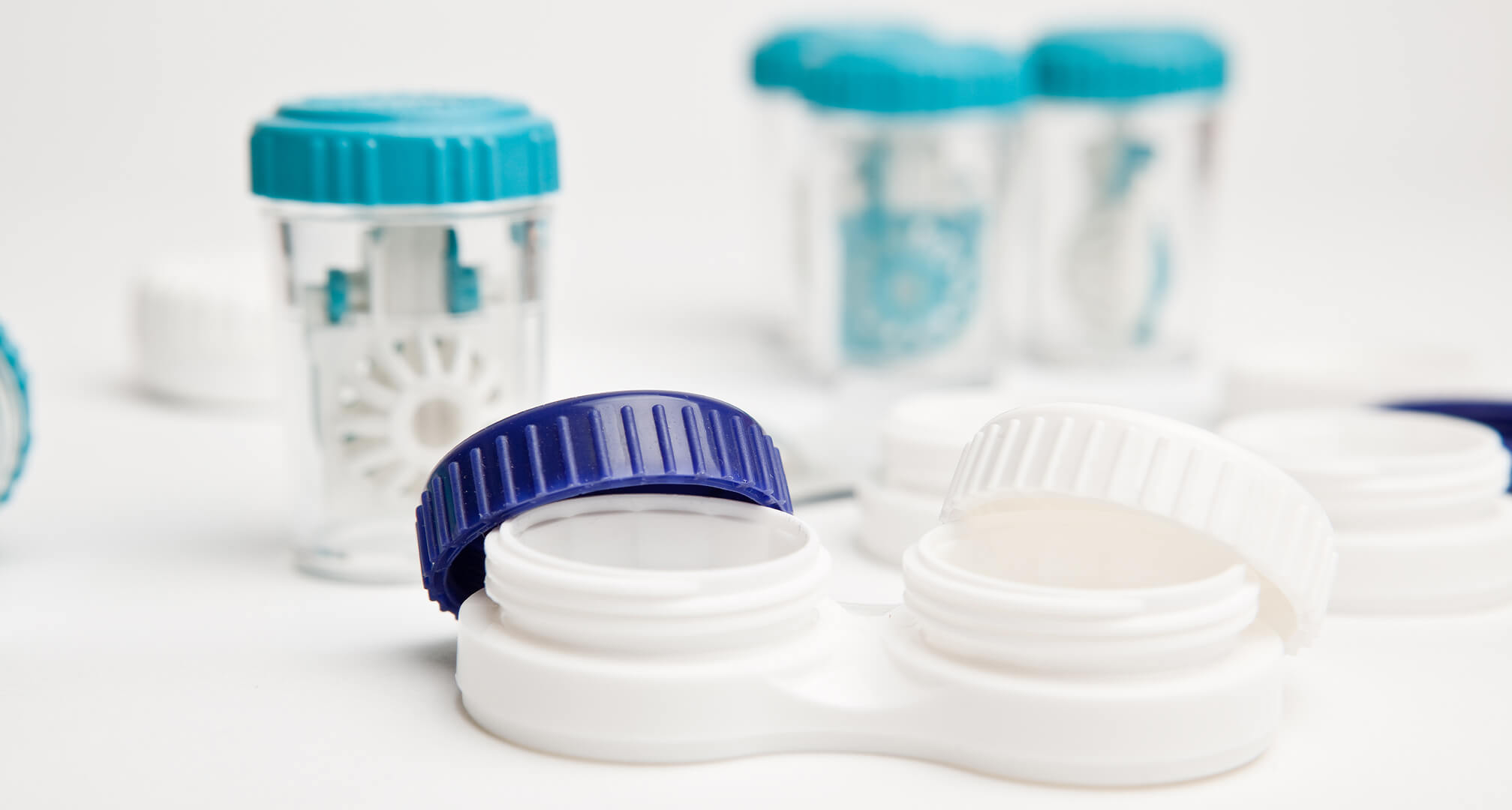 open contact lenses case with peroxide cases in background