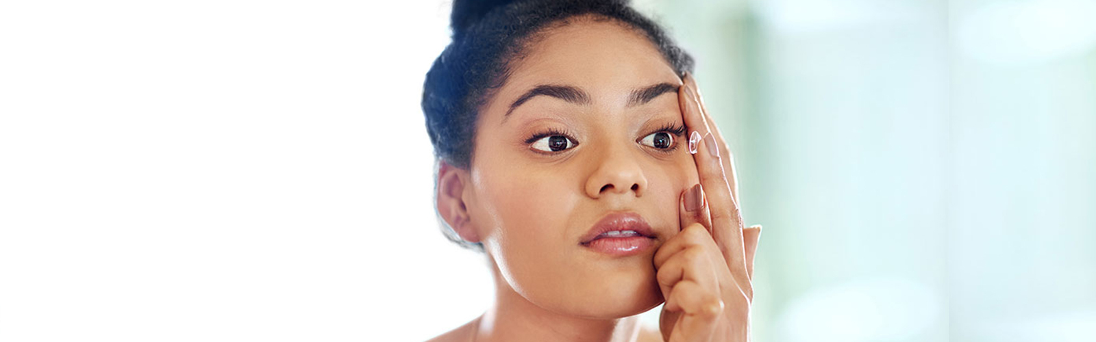 Woman applying contact lenses